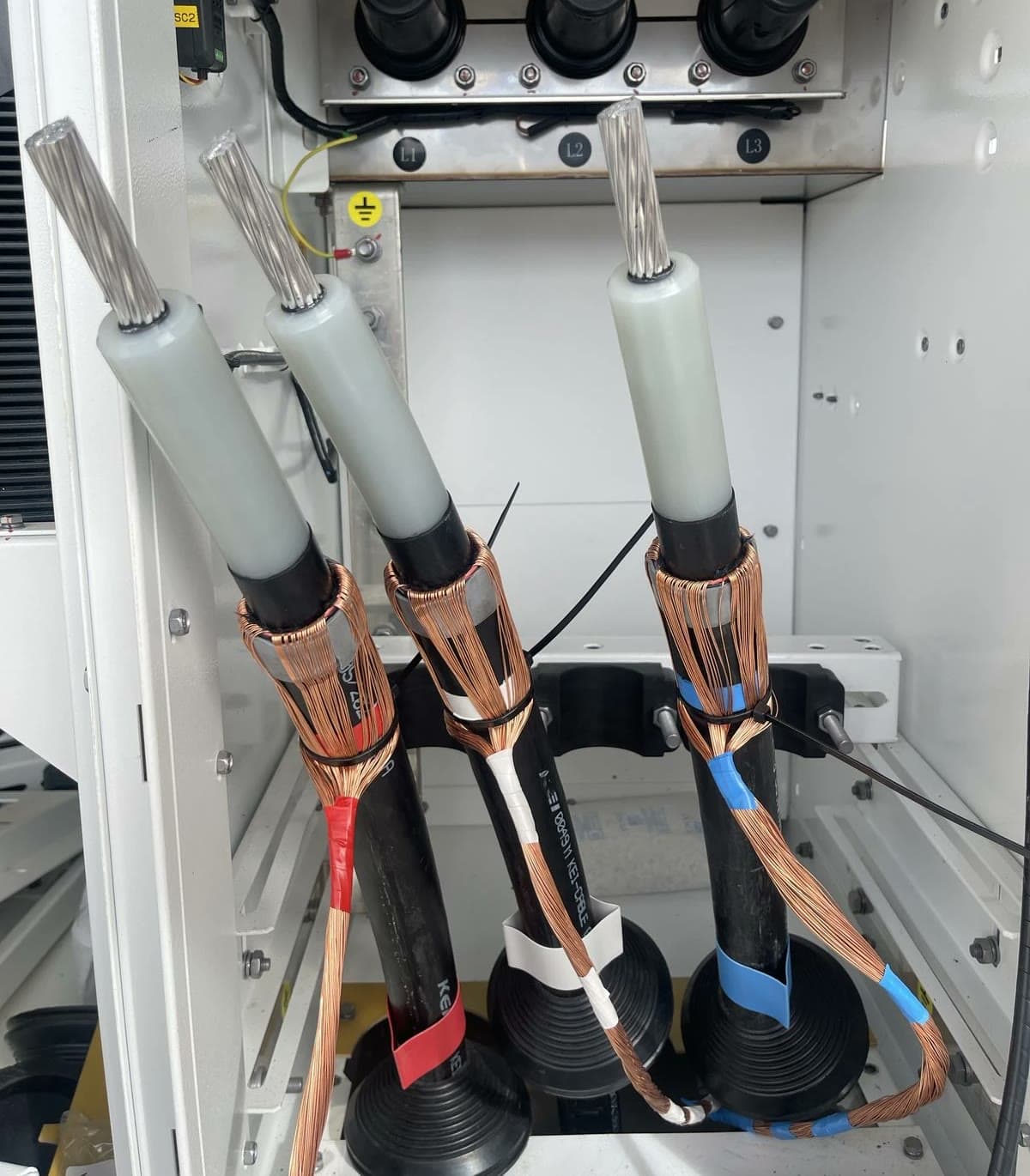 Long runs of power and control cabling dressed on cable trays at an industrial facility