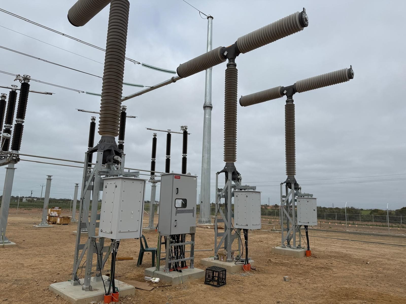 High-voltage disconnectors and busbars against a big South Australian sky